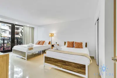 a bedroom with two beds and a balcony at Beautiful 2 Br Apartment Amazing Pool in Miami Beach