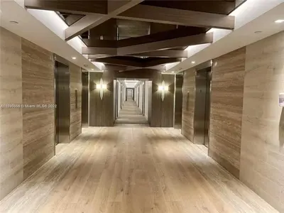 a hallway of a building with wooden floors and ceilings at Romantic-5 star-1BR-Oceanfront-Balcony-South-Beach in Miami Beach