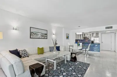a living room with a couch and a table at Romantic-5 star-1BR-Oceanfront-Balcony-South-Beach in Miami Beach