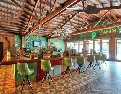 a bar in a restaurant with green bar stools at Coco Sol 1 by MyMiamiStay in Miami