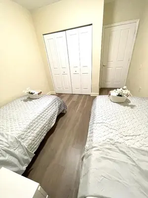 two beds in a room with two doors at Private bedroom in Miami - Coral Gables 601 in Miami