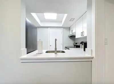 a kitchen with a sink in a white kitchen at Cordova Arms By Rocketstay in Fort Lauderdale