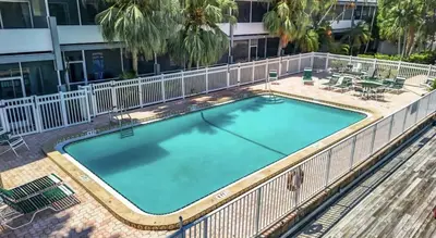 a large swimming pool with a fence around it at Cordova Arms By Rocketstay in Fort Lauderdale