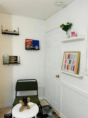a room with a chair and a stool with a teddy bear at Studio with Terrace Near Hard Rock-Patio in Fleetwood Manor
