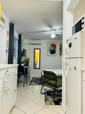 a kitchen with a refrigerator and a dining room at Studio with Terrace Near Hard Rock-Patio in Fleetwood Manor