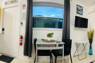 a small table and chairs in a room with a window at Studio with Terrace Near Hard Rock-Patio in Fleetwood Manor