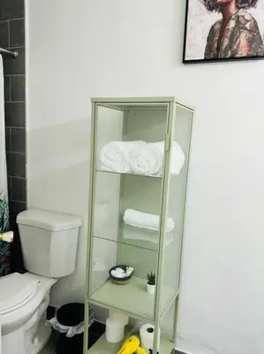 a bathroom with a toilet and a glass shelf with towels at Studio with Terrace Near Hard Rock-Patio in Fleetwood Manor