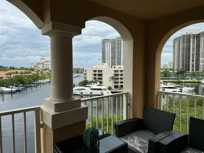 a balcony with a view of the water and buildings at The Costal, stunning water view apartment at Aventura Yacht Club, Miami Florida! in Sun Swept Isles