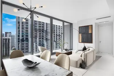 a living room with a table and chairs and a large window at ASTON MARTIN TOWER Miami in Miami