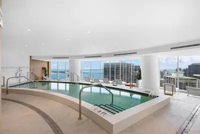 a large swimming pool in a building with a view at ASTON MARTIN TOWER Miami in Miami