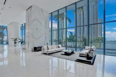 a living room with white furniture and large windows at ASTON MARTIN TOWER Miami in Miami