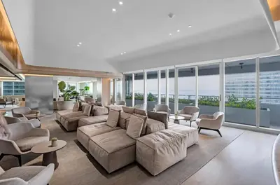 a large living room with couches and chairs and windows at Brickell High Floor AKA Free Parking by Palermo Home Miami in Miami