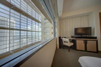 a hotel room with a large window and a television at Brickell High Floor AKA Free Parking by Palermo Home Miami in Miami