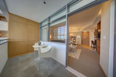 a kitchen and living room with a large glass wall at Brickell High Floor AKA Free Parking by Palermo Home Miami in Miami