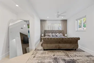 a bedroom with a bed and a mirror at Villa Verde - Your Exclusive Luxury Escape with Private Pool and Mini Golf in Miami