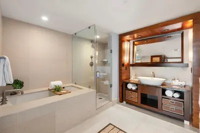a bathroom with a tub and a sink and a mirror at 2 Bedroom Private Residence at Carillon Miami Resort -522 in Miami Beach