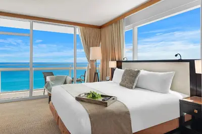 a hotel room with a bed with a view of the ocean at 2 Bedroom Private Residence at Carillon Miami Resort -522 in Miami Beach