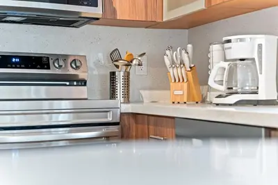 a kitchen with stainless steel appliances and a counter top at Luxurious Family Escape in Hialeah