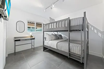 a bedroom with a bunk bed and a desk at Luxurious Family Escape in Hialeah