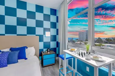 a room with a bed and a window with a view at Luxurious Condo with Rooftop Pool Hot Tub in Hollywood