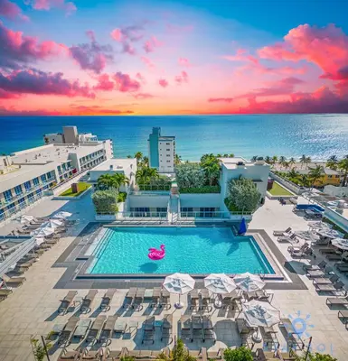 a pool with chairs and umbrellas and the ocean at Luxurious Condo with Rooftop Pool Hot Tub in Hollywood