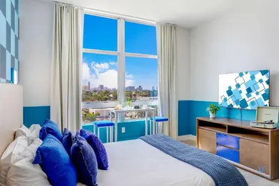 a bedroom with a bed and a large window at Luxurious Condo with Rooftop Pool Hot Tub in Hollywood