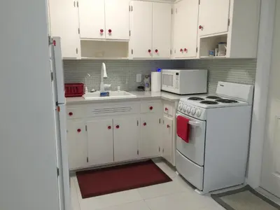 a kitchen with white cabinets and a white stove top oven at Downtown Hollywood Boutique Hotel in Hollywood