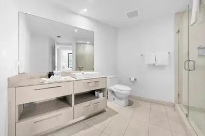 a white bathroom with a sink and a toilet at Breathtaking Ocean-View Balcony Lyfe Resort in Hollywood Beach