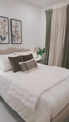 a white bed with two pillows on top of it at Charming Home Close to Beaches & Downtown in Miami