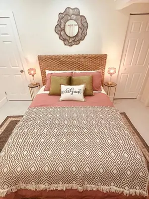 a bedroom with a large bed and a mirror at Charming Home Close to Beaches & Downtown in Miami