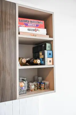 a shelf in a kitchen with books and other items at Magic Miami Penthouse, Ocean & City Views, Pool, Spa, Gym, in Miami
