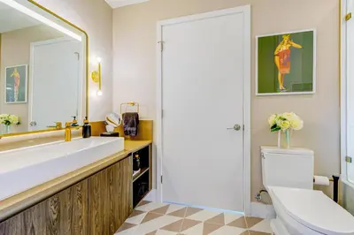 a bathroom with a sink and a toilet and a mirror at Magic Miami Penthouse, Ocean & City Views, Pool, Spa, Gym, in Miami