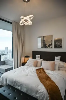 a bedroom with a large bed with a large window at Magic Miami Penthouse, Ocean & City Views, Pool, Spa, Gym, in Miami