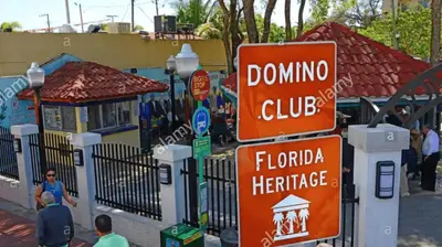 a bunch of street signs in front of a fence at Coco Sol 3 by MyMiamiStay in Miami