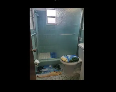 a bathroom with a shower and a toilet and a sink at Coco Sol 3 by MyMiamiStay in Miami