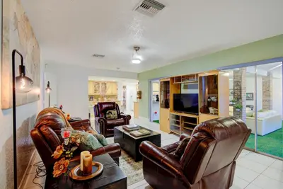 a living room with two leather chairs and a television at Classic Modern 3-Bedroom Oasis in Fort Lauderdale