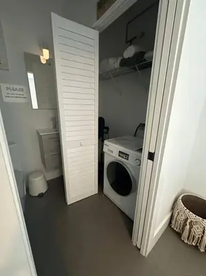 a laundry room with a washing machine and a door at Charming House at Miami's Heart in Miami