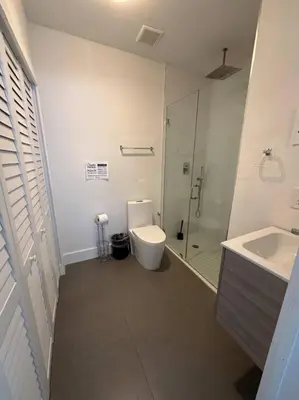 a bathroom with a toilet and a shower and a sink at Charming House at Miami's Heart in Miami