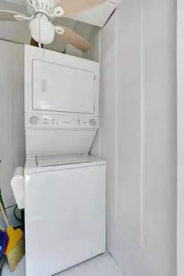 a white kitchen with a microwave and a refrigerator at Fort Lauderdale Home near Nightlife and Beach in Fort Lauderdale
