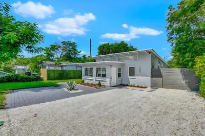 a white house with a driveway at Fort Lauderdale Home near Nightlife and Beach in Fort Lauderdale