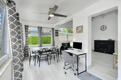 a living room with a table and chairs at Fort Lauderdale Home near Nightlife and Beach in Fort Lauderdale
