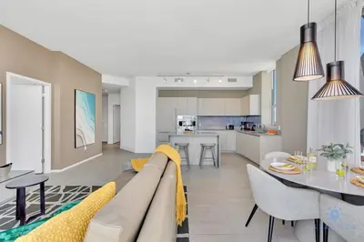 a living room and kitchen with a couch and a table at Penthouse with Free Parking and Beautiful Amenities in Hollywood