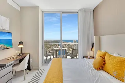 a bedroom with a bed and a desk and a large window at Penthouse with Free Parking and Beautiful Amenities in Hollywood