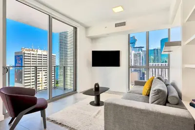 a living room with a couch and large windows at Gorgeous Unit in the Heart of Downtown Miami in Miami