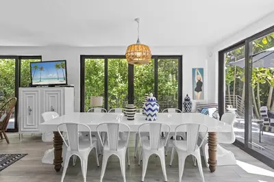 a white dining room with a white table and chairs at The Waterhouse- Amazing Villa With Infinity Pool in Miami