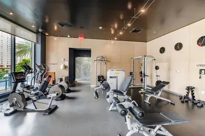 a gym with several treadmills and cardio machines at Beachwalk - 1 Bedroom & Kitchen Amazing Bay view in Hallandale Beach