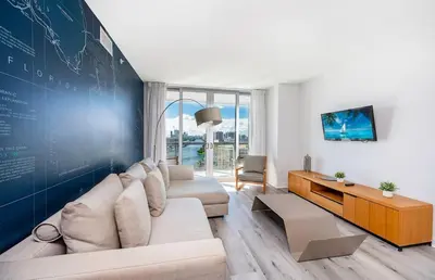 a living room with a couch and a large wall at 2 Bed 2 Bath With Amazing Bay View And Luxury Pool in Hallandale Beach