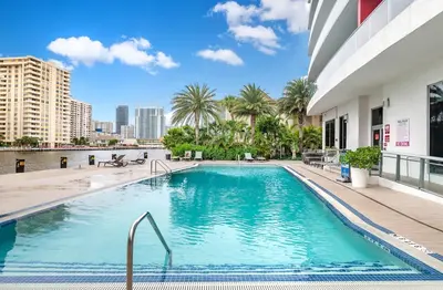 a swimming pool in the middle of a building at Beachwalk Family Studio- Beach Pool Gym & Bay View in Hallandale Beach