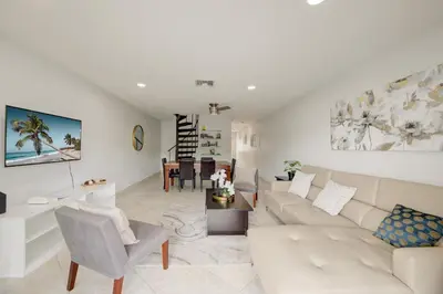 a living room with a couch and a table at Cozy Retreat in Fort Lauderdale