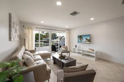a living room with a couch and a table at Cozy Retreat in Fort Lauderdale